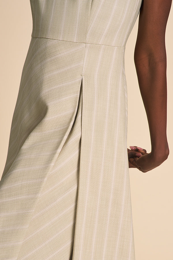 Close-up of a beige dress with vertical stripes on a beige background | Exclude | Grid Hover