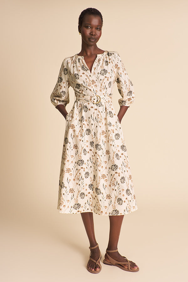 Woman wearing a floral dress on a beige background | Exclude | Grid