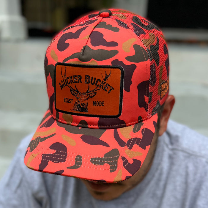 mucker bucket - "beast mode" orange camo trucker hat on model