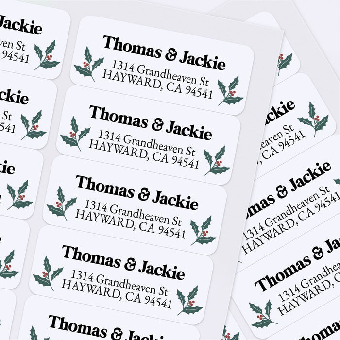 Custom Christmas return address labels on pink and burgundy envelopes, decorated with festive holly branch motifs and printed text - XOXOKristen