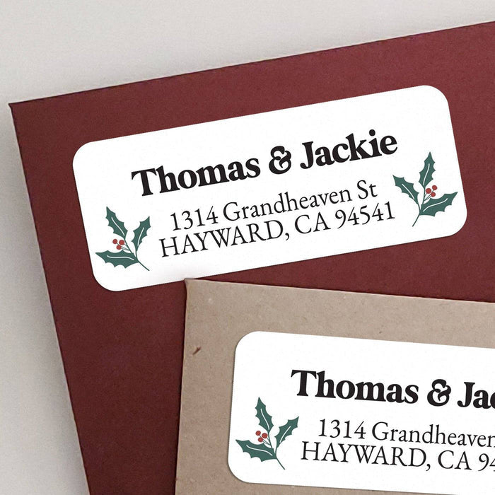 Personalized rectangular return address label with white background, green holly leaves, red berry illustrations, and bold black typography - XOXOKristen