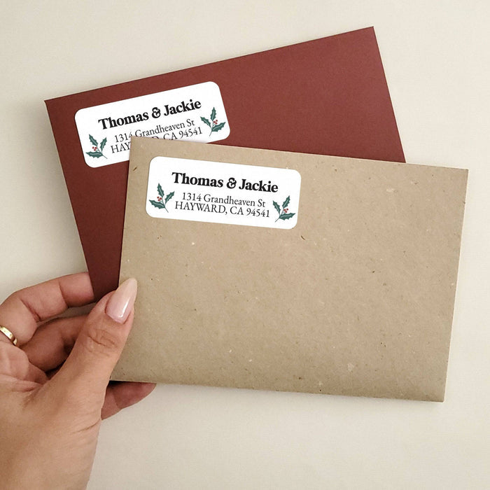 Personalized rectangular return address label with white background, green holly leaves, red berry illustrations, and bold black typography - XOXOKristen