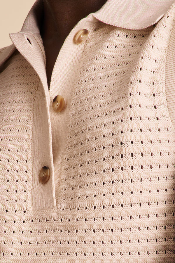 Close-up of a beige textured sweater with button details | Exclude | Grid Hover