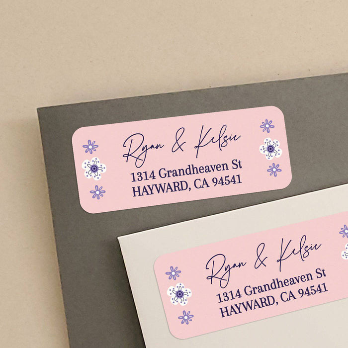 Personalized rectangular return address label with soft pink background, purple floral accents, and modern black script typography - XOXOKristen