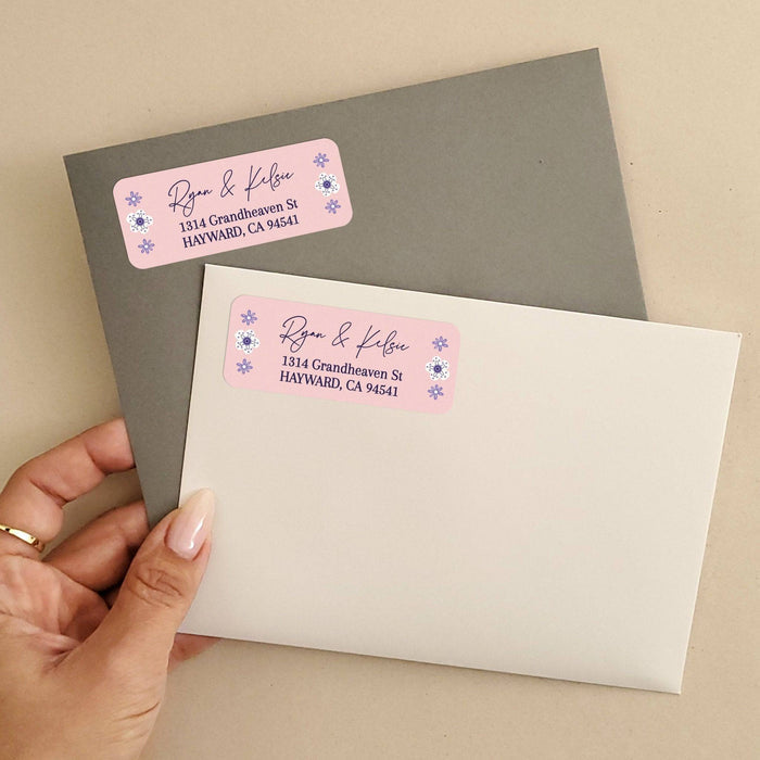 Personalized rectangular return address label with soft pink background, purple floral accents, and modern black script typography - XOXOKristen